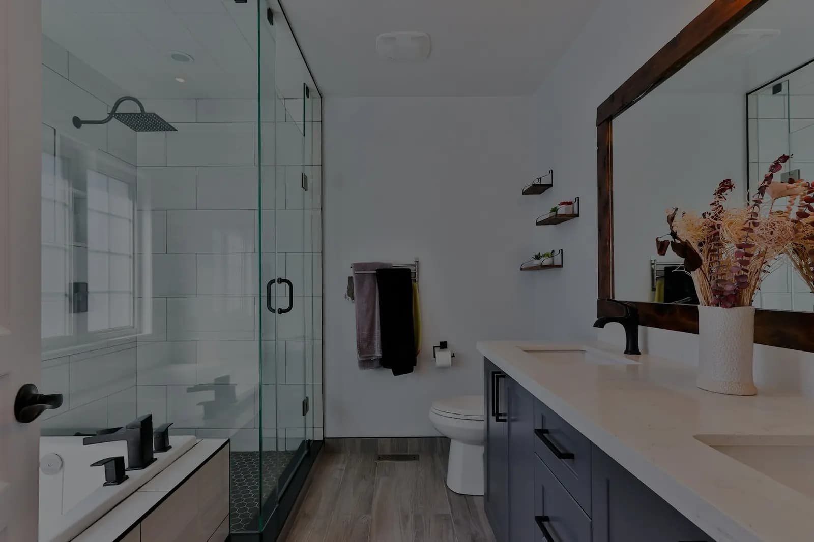 A refitted bathroom with a walk-in shower, a vanity unit and a large framed mirror